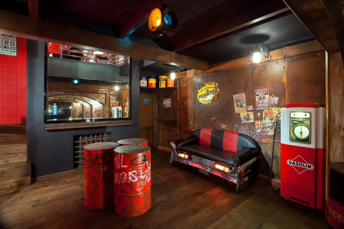 The underground American gas station with barrels and a couch