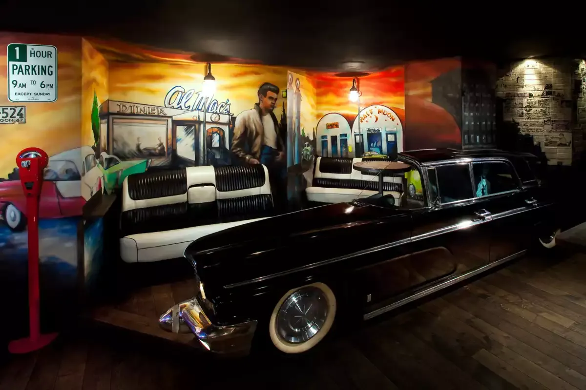 The Lincoln lounge with a car and murals