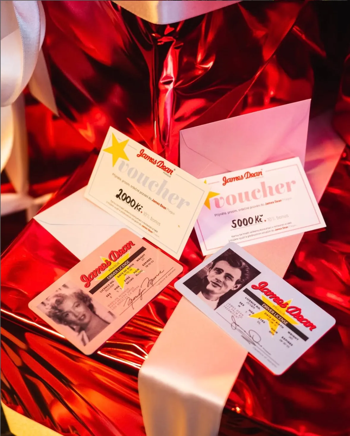 James Dean gift vouchers for 2,000 and 5,000 CZK and Driver’s License cards on a red gift box