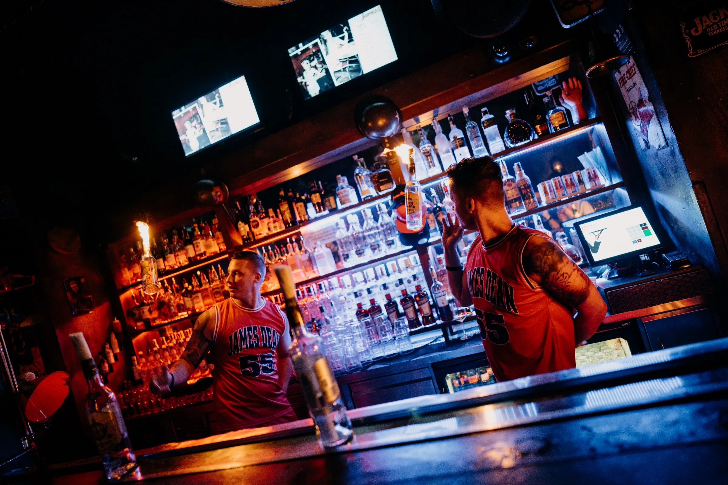Bartenders in James Dean jerseys behind the Music Club bar