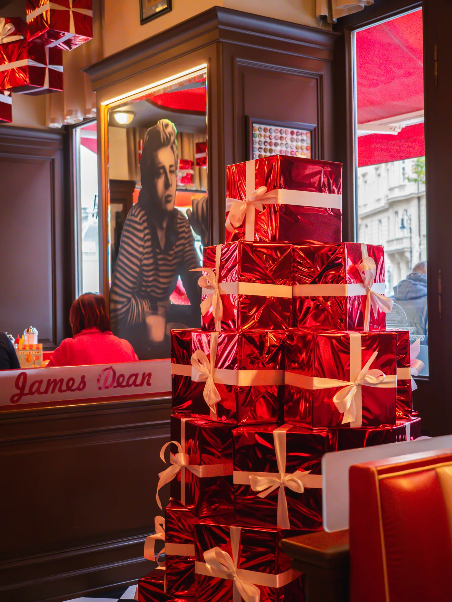 A tower of red gift boxes with white bows at James Dean Prague